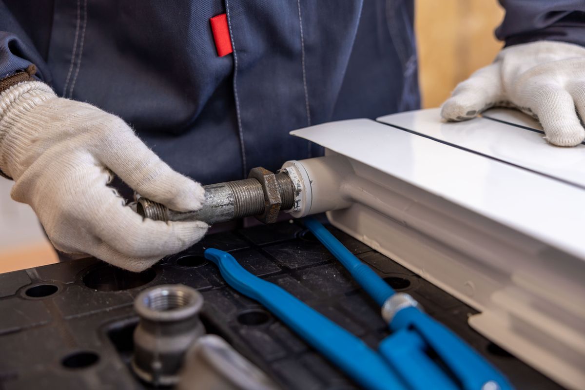 Licensed commercial plumber servicing a mechanical room in a Sacramento facility