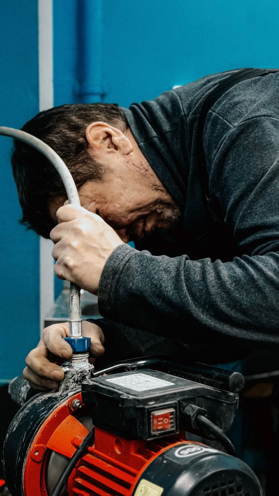 Commercial plumbing technician inspecting a backflow assembly