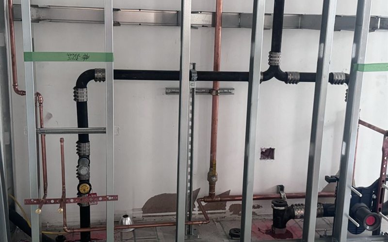Commercial kitchen gas and water line rough-in with copper and ABS piping in a Sacramento building