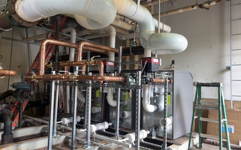 Commercial water heaters installed with a copper manifold in a Sacramento boiler room